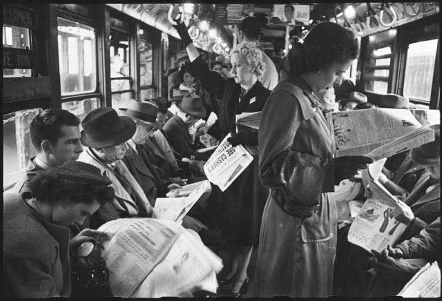 Old-time photo of New Yorkers reading their newspapers on the subway